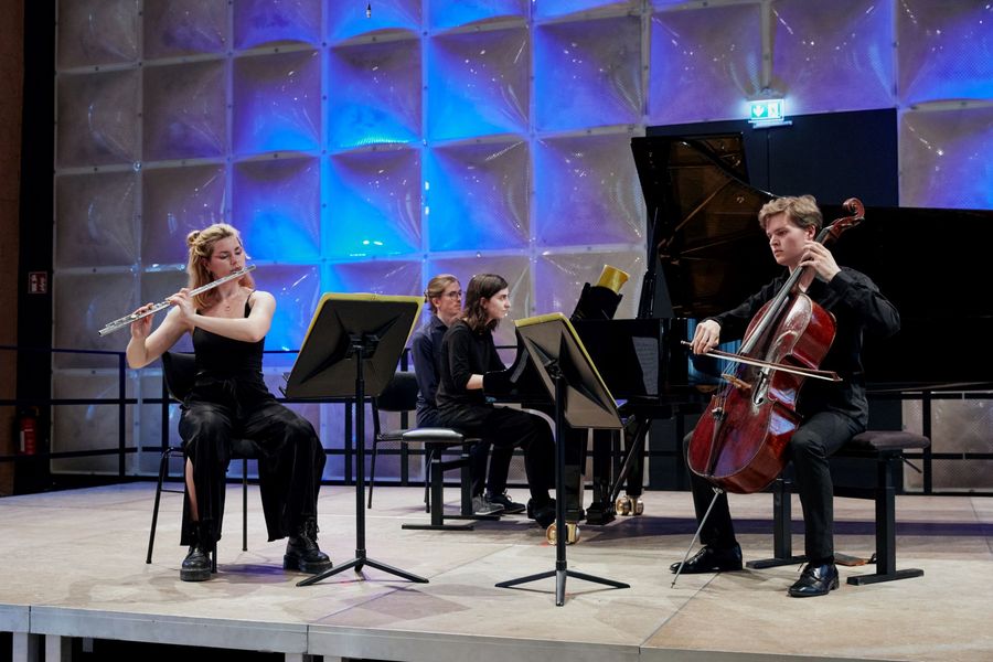 Trio bestehend aus Querflöte, Cello und Klavier spielen auf der Bühne