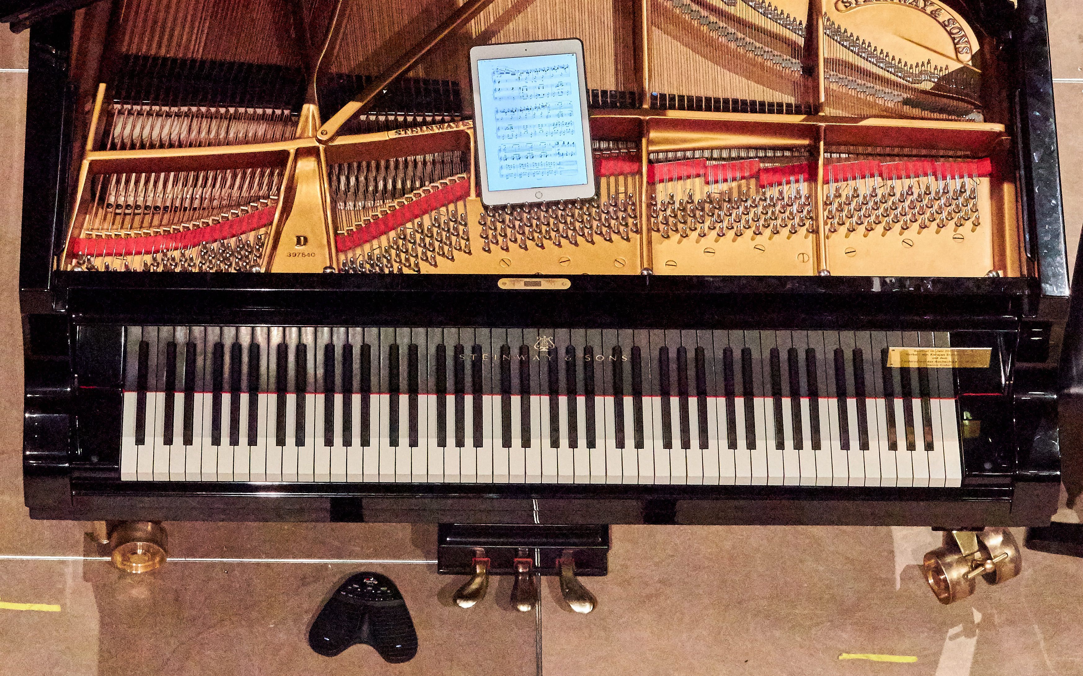 Open grand piano with tablet on top 