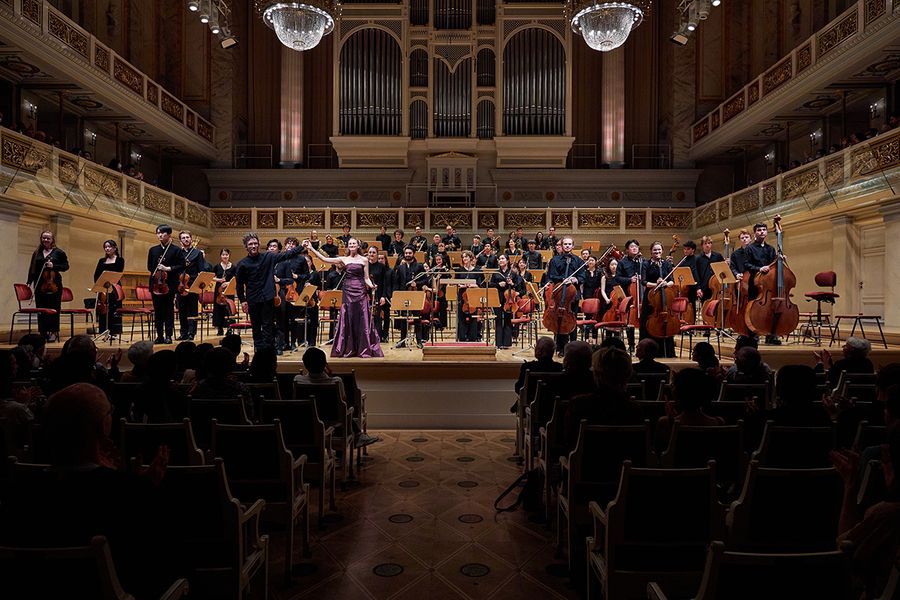 Dirigent und Solistin stehen vor dem Orchester zum Applaus auf der Bühne des Berliner Konzerthauses